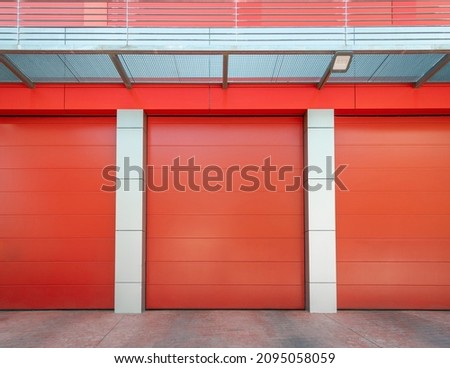 Empty Red metal warehouse with closed roller shutter door