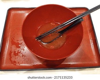 Empty Red Ramen Bowl With Spoon And Chopsticks Inside On The Red Tray After Diner 