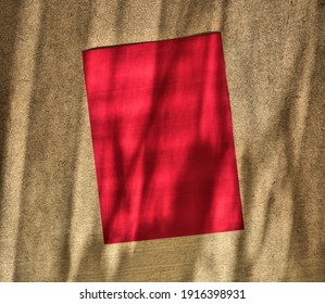 Empty Red Rectangle Poster Mockup With Soft Shadow On Golden Beige Wall Background. Flat Lay, Top View