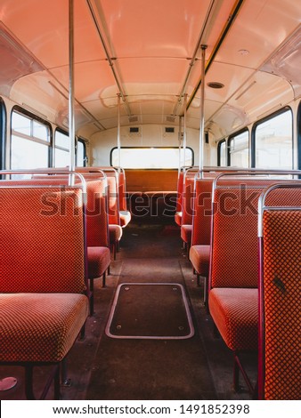 Empty red seats on an old school bus