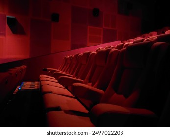 Empty red seats in platinum cineplex cinema In the dark inside the cinema