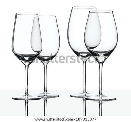 Empty red and white wine glasses isolated on white with reflection.