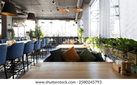 Empty restaurant interior while coronavirus pandemic, no people, soft sofas with pillows, copy space