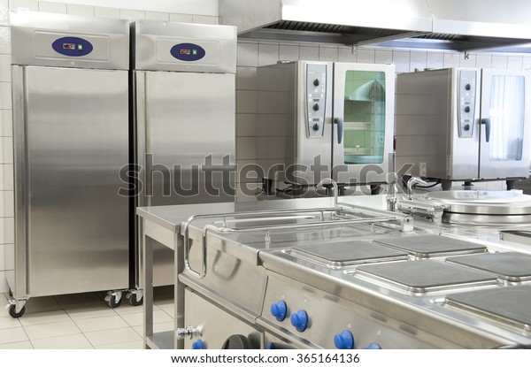 Empty\
restaurant kitchen with professional\
equipment
