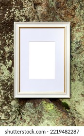 Empty Retro Ancient Frame Mockup With Copy Text Space On Mossy Rock Wall Texture