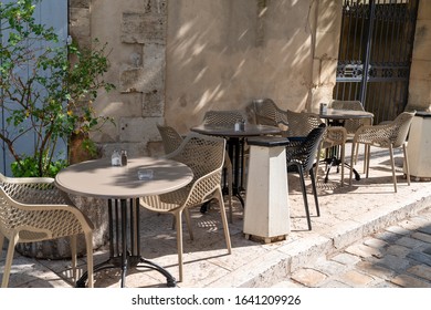 Empty Retro Tables And Chairs On A Outdoor Cafe Terrace In Avignon France 