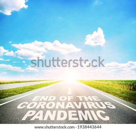 The empty road between the meadow and the text on the asphalt 