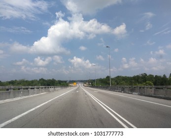 Empty road with cloudscape background