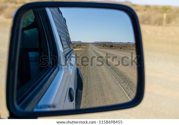 empty\
road in the desert - view in the car mirror\
namibia