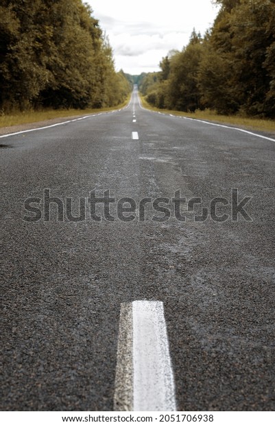 An empty road with a\
dividing strip