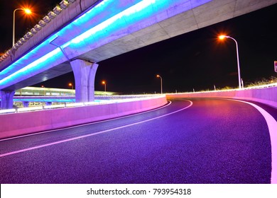 Empty Road Floor With City Overpass Viaduct Bridge Of Neon Lights Night Scene