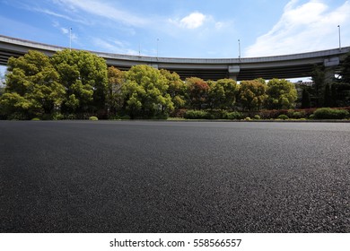 Empty road floor surface with city viaduct overpass bridge background
