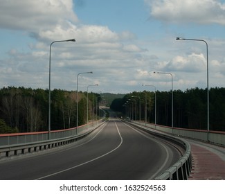 Empty road going into a forest in Lithuania