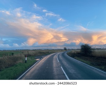 Empty road heading into the sunset