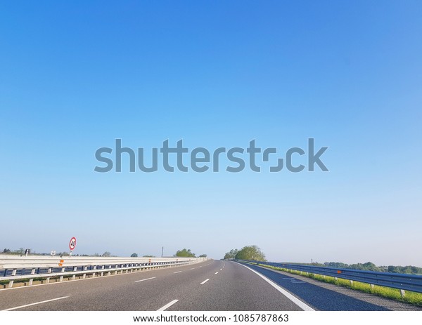Empty road highway in countryside with blue\
sky natural background.