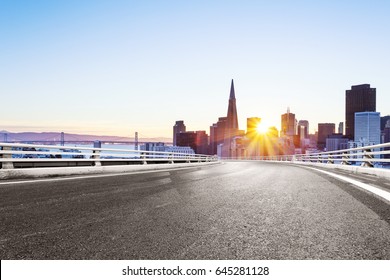 Empty Road With Landmark Buildings In San Francisco At Sunrise