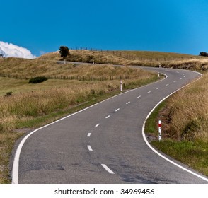 Empty road leading into cloud over the horizon