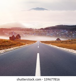 Empty Road Leading To The Mountain Town