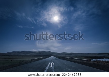 empty road in the moonlight at night