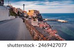 Empty road of Scilla town with Ruffo castle on background. Impressive summer cityscape of Scilla port, Reggio Calabria, Italy, Europe. Colorful morning seascape of Mediterranean sea. Travel the world.