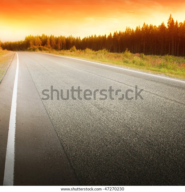 Empty road at\
sunset.