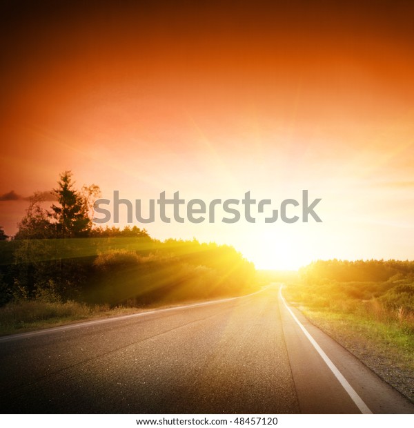 Empty road at\
sunset.