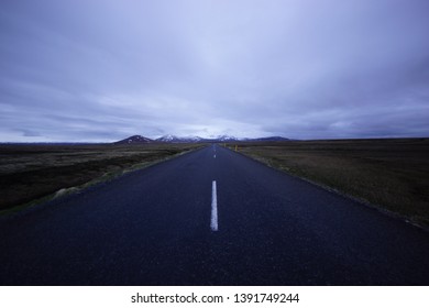 Empty road under the cloudy sky