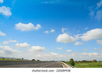 empty road under a cloudy sky