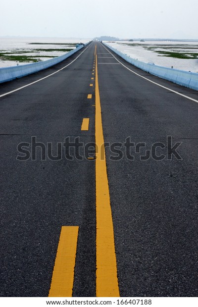 Empty road and the\
yellow traffic lines.