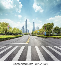 Empty Road With Zebra Crossing And Skyscrapers In Modern City