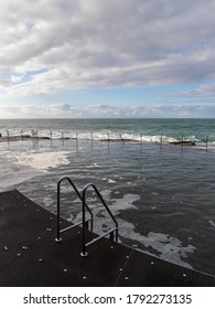 Empty rock pool with cloudy sky.