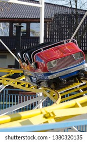 An Empty Roller Coaster Car In An Amusement Park