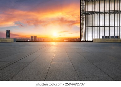Empty rooftop platform with city skyline and dramatic sunrise background