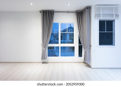 Empty Room Or Bedroom In Perspective At Night. Interior Inside House Building With Wooden Laminate Floor, Wall, Window, Adjusting Vertic, Curtains And Light. New And Clean Look Modern For Background.