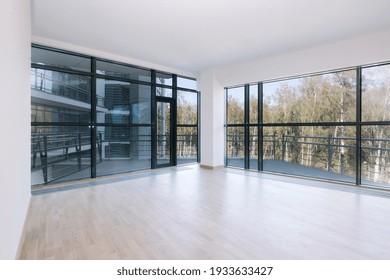 Empty Room With Big Window In Loft Style. Clean And Bright Space For Office. Real Estate