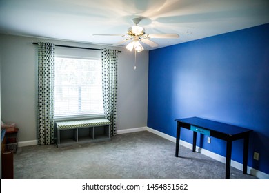 Empty Room With A Blue Accent Wall In A House After Child Moves Out And Parent Is An Empty Nester