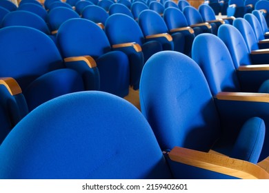 An Empty Room With Blue Cinema Seats