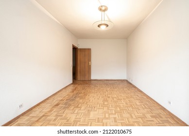 Empty Room With French Oak Parquet Flooring And Cream Colored Walls