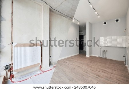 Empty room with installed heating system before and after restoration. Comparison of old apartment and new renovated flat with parquet floor, radiator and white wall. Home renovation concept.