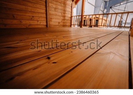 Empty room interior with rustic timbers and wood floors.