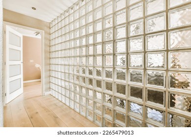 an empty room with lots of glass blocks on the wall and wood flooring in front of the window panes - Shutterstock ID 2265479013