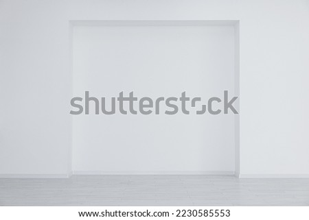 Empty room with niche in white wall during repair