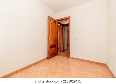 Empty Room With Orange Stoneware Floor, Mahogany Wood Door And White Painted Walls