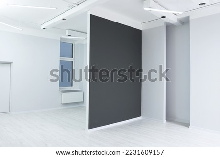 Empty room with partition wall and window during repair