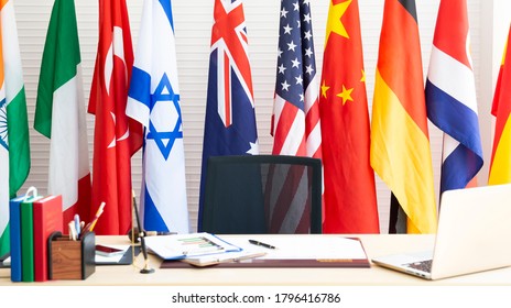 Empty room for president or government statesman with laptop, year planner, business charts and diagram, pen on wooden table and various international flag. Country Leader Room with flags. Press room. - Powered by Shutterstock