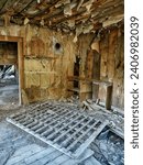 An empty room shows peeling wallpaper and some mattress springs in the ghost town of Bodie, Washington.