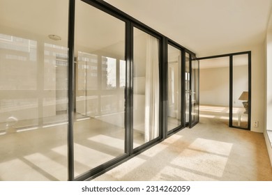 an empty room with sliding glass doors and floor to ceiling windows in a new apartment building, london, uk stock photo