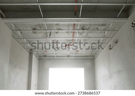 empty room in the structural preparation phase for ceiling installation in a high-rise residential construction project.