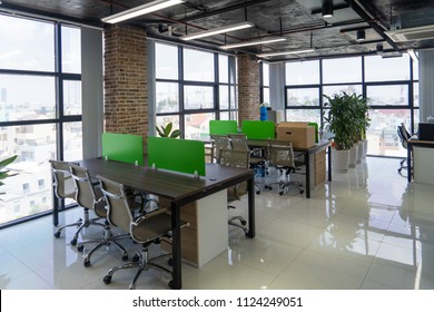 Empty Room With Tables In Modern Office. Open Space In Loft Style Office Building. Interior Concept