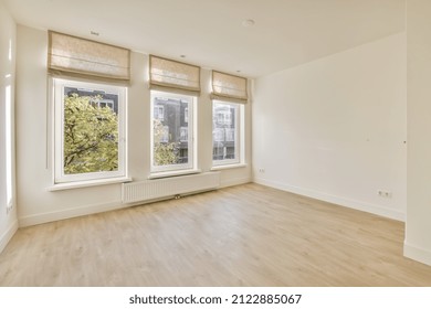 an empty room with three large windows